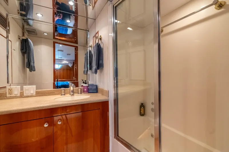 Slide: The Image of Luxurious bathroom in 2000 Hatteras 75 Sport Deck Motor Yacht with shower and vanity. - 59