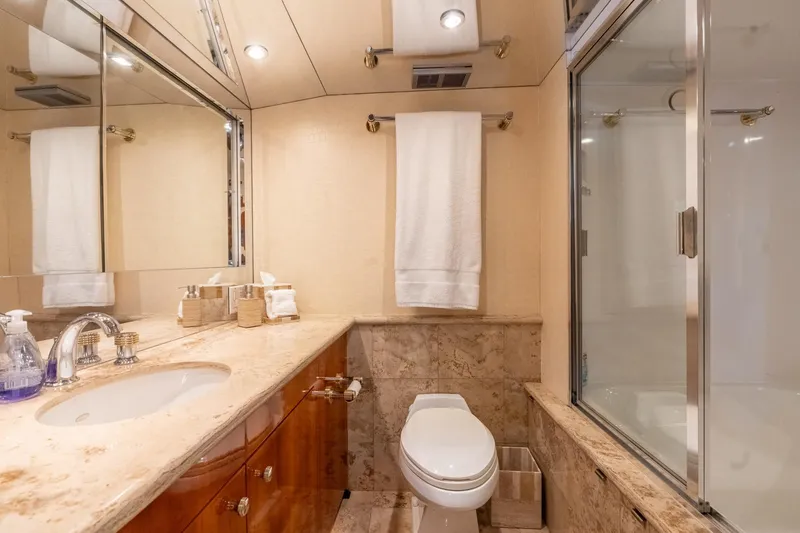 Slide: The Image of Luxurious bathroom in 2000 Hatteras 75 Sport Deck Motor Yacht with marble countertop and shower. - 54
