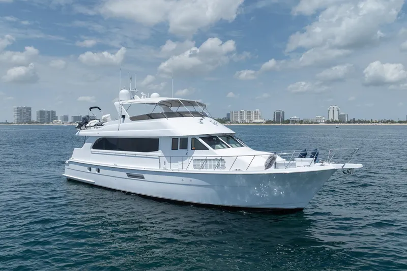 Slide: The Image of Luxury 2000 Hatteras 75 Sport Deck Motor Yacht cruising on open water. - 2