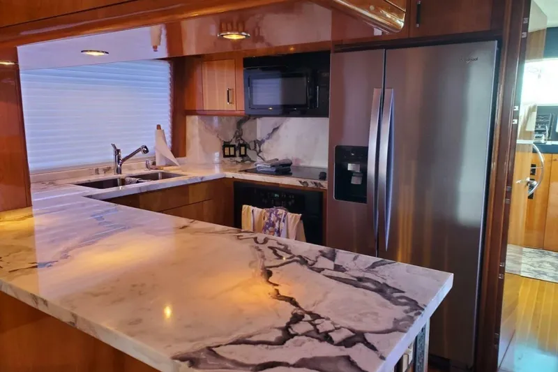 Slide: The Image of Luxurious kitchen interior of 2000 Hatteras 75 Sport Deck Motor Yacht with marble countertops. - 6