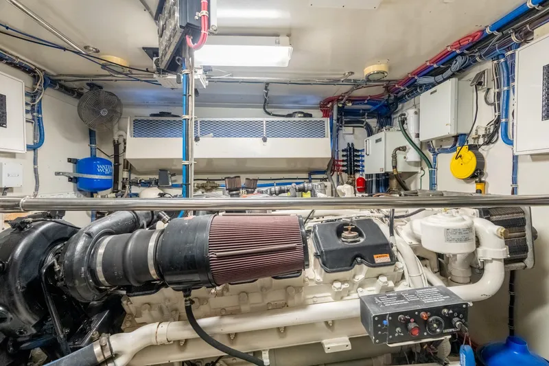 Slide: The Image of Engine room of 2000 Hatteras 75 Sport Deck Motor Yacht, showcasing machinery and wiring. - 71