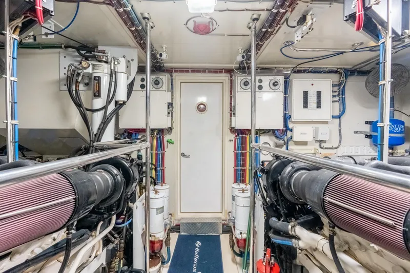 Slide: The Image of Engine room of 2000 Hatteras 75 Sport Deck Motor Yacht, showcasing machinery and equipment. - 69