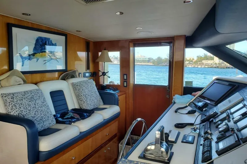Slide: The Image of Interior of 2000 Hatteras 75 Sport Deck Motor Yacht with plush seating and control panel. - 7