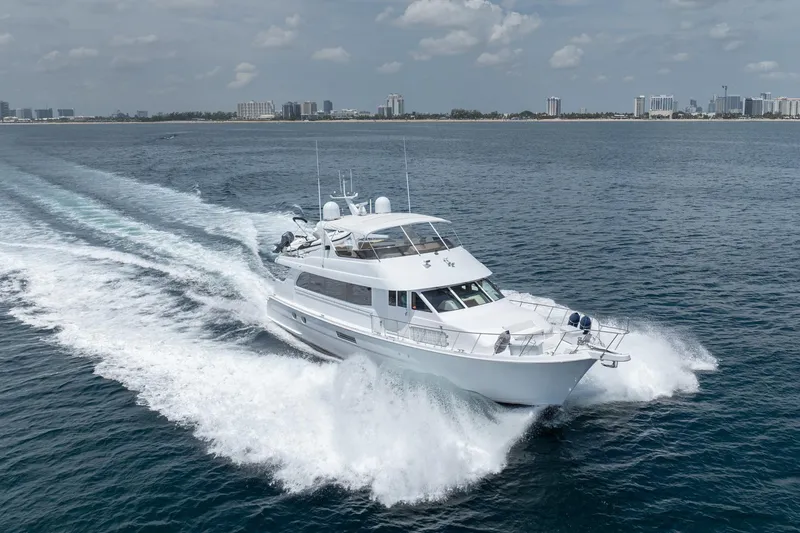 Slide: The Image of 2000 Hatteras 75 Sport Deck Motor Yacht cruising on open water. - 11