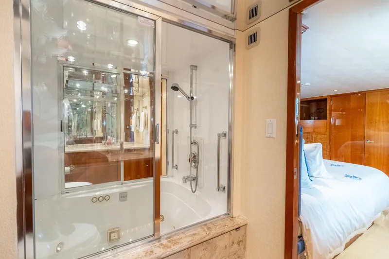 Slide: The Image of Luxurious bathroom and bedroom on a 2000 Hatteras 75 Sport Deck Motor Yacht. - 55