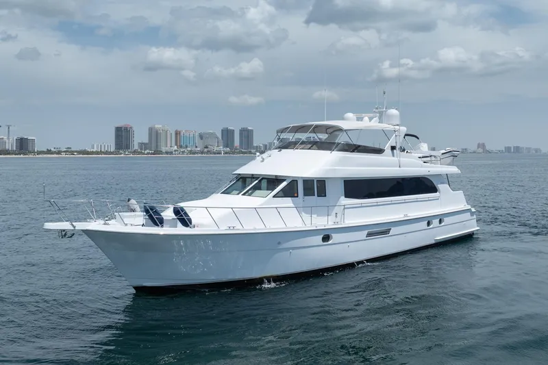 Slide: The Image of A 2000 Hatteras 75 Sport Deck Motor Yacht cruising near a city skyline. - 4