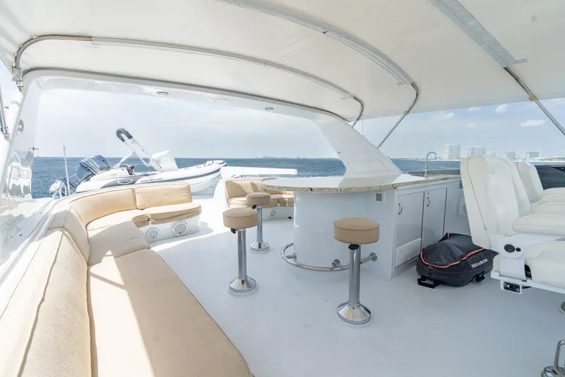 Slide: The Image of Luxurious 2000 Hatteras 75 Sport Deck Motor Yacht with spacious seating and ocean view. - 29