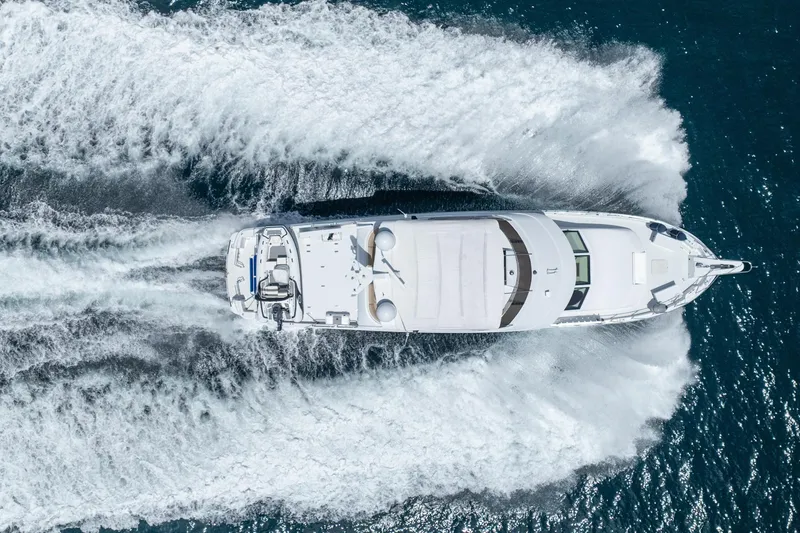 Slide: The Image of Aerial view of 2000 Hatteras 75 Sport Deck Motor Yacht cruising on open water. - 12