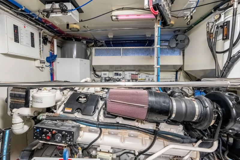 Slide: The Image of Engine room of 2000 Hatteras 75 Sport Deck Motor Yacht, showcasing mechanical components. - 70