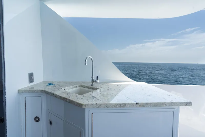 Slide: The Image of Luxurious yacht sink area with ocean view on 2000 Hatteras 75 Sport Deck Motor Yacht. - 24