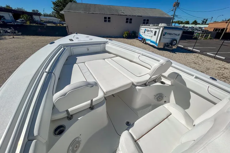 Slide: The Image of 2018 Sea Hunt Gamefish 27 boat interior with white seating and spacious deck. - 10