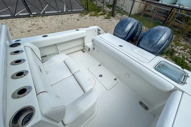 Slide: The Image of 2018 Sea Hunt Gamefish 27 boat interior with dual Yamaha engines and seating area. - 5