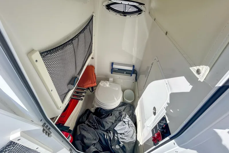 Slide: The Image of 2018 Sea Hunt Gamefish 27 boat interior with storage and marine toilet. - 8