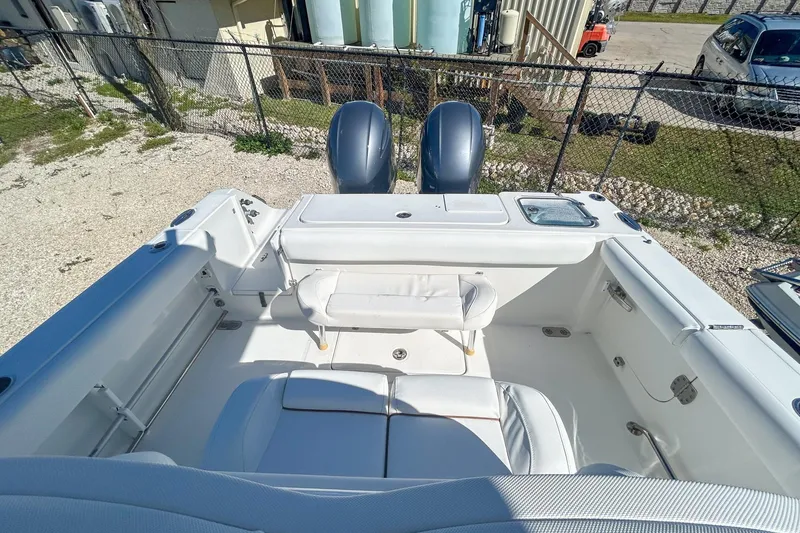 Slide: The Image of 2018 Sea Hunt Gamefish 27 boat interior with dual engines and seating area. - 9