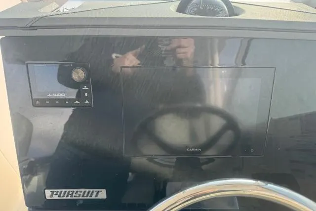 Slide: The Image of 2023 Pursuit DC 295 Dual Console dashboard with Garmin and JL Audio systems. - 35