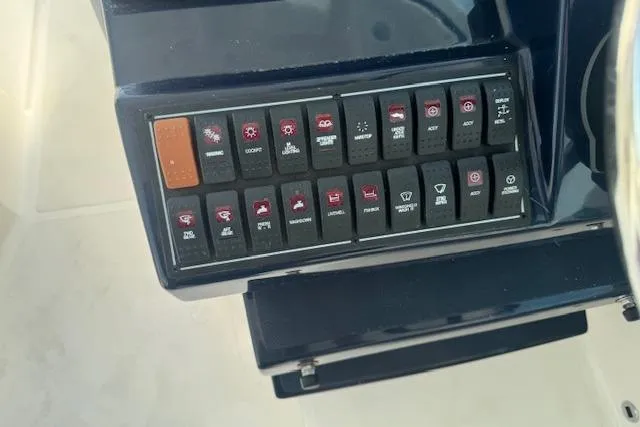 Slide: The Image of Control panel of 2023 Pursuit DC 295 Dual Console boat with labeled switches. - 36