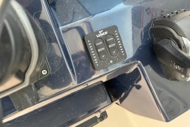 Slide: The Image of Control panel of 2023 Pursuit DC 295 Dual Console boat with Lenco trim tab switches. - 37