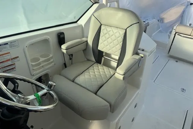 Slide: The Image of Captain's seat on 2023 Pursuit DC 295 Dual Console boat, featuring quilted upholstery. - 39