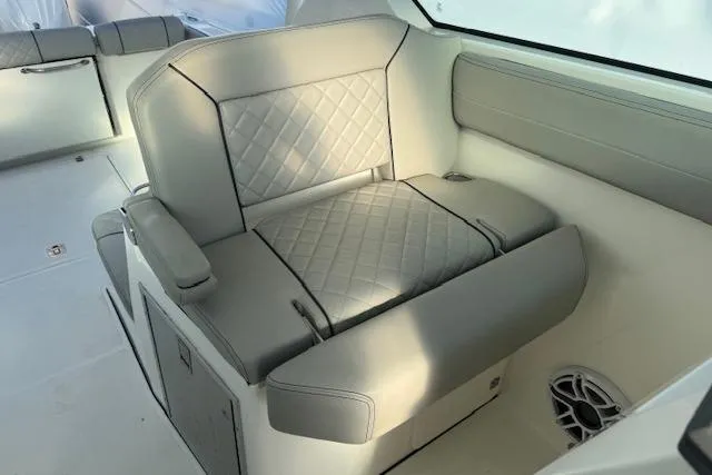 Slide: The Image of 2023 Pursuit DC 295 Dual Console boat interior with cushioned seating and modern design. - 40