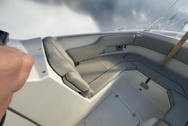 Slide: The Image of 2023 Pursuit DC 295 Dual Console boat interior with cushioned seating and sleek design. - 52