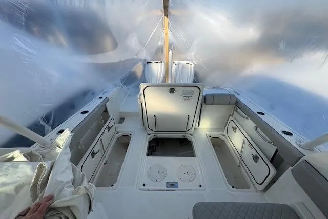 Slide: The Image of 2023 Pursuit DC 295 Dual Console boat interior with storage compartments and seating. - 54