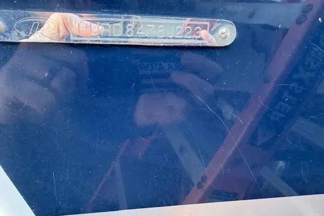 Slide: The Image of 2023 Pursuit DC 295 Dual Console boat identification plate with reflection. - 55