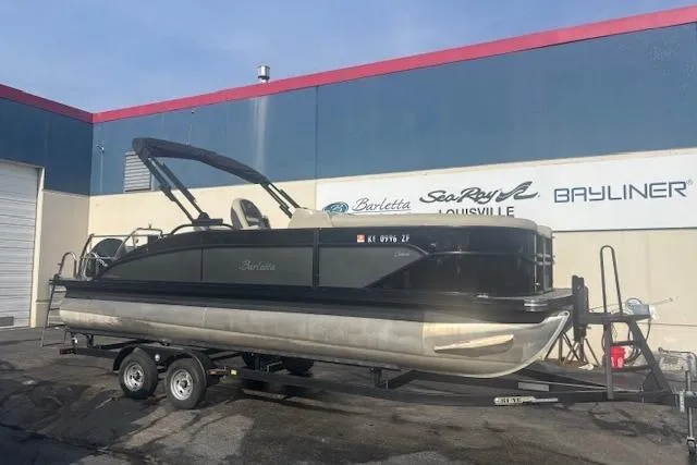 The Image of 2023 Barletta C22UC pontoon boat on trailer outside dealership. - 0