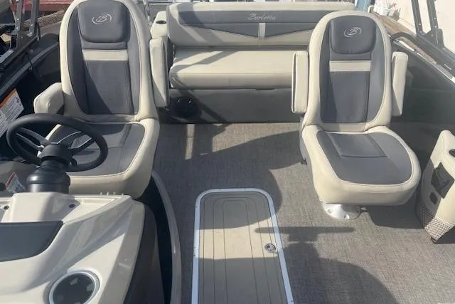 Slide: The Image of 2023 Barletta C22UC boat interior with plush seating and steering console. - 4