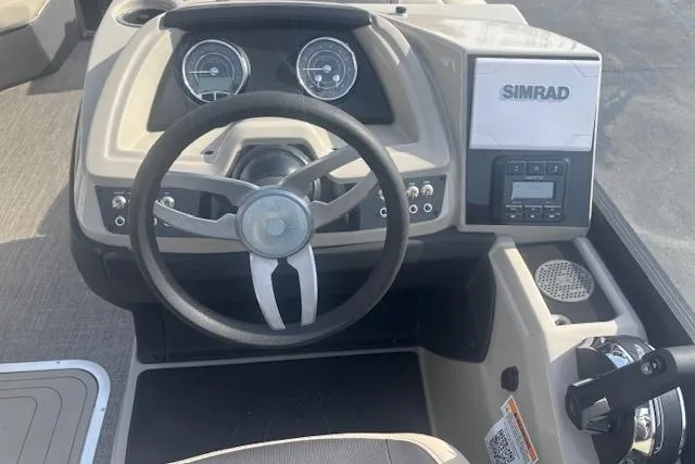 Slide: The Image of 2023 Barletta C22UC boat dashboard with steering wheel and Simrad navigation system. - 6