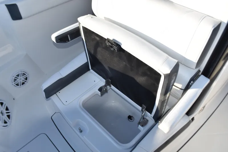 Slide: The Image of 2022 Blackfin 272 CC boat seat with storage compartment open. - 16