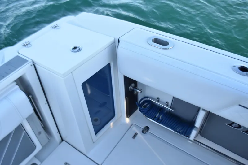 Slide: The Image of 2022 Blackfin 272 CC boat deck with storage and coiled hose. - 27