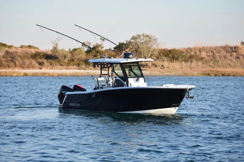 Slide: The Image of 2022 Blackfin 272 CC boat on water with fishing rods, scenic background. - 5