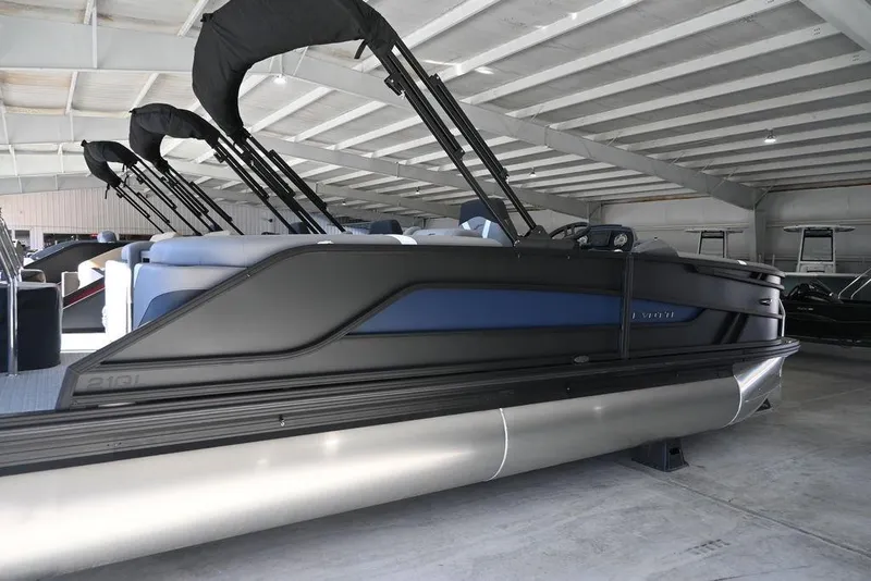 Slide: The Image of 2026 Evotti 521QL pontoon boat in a showroom, featuring sleek design and modern amenities. - 4