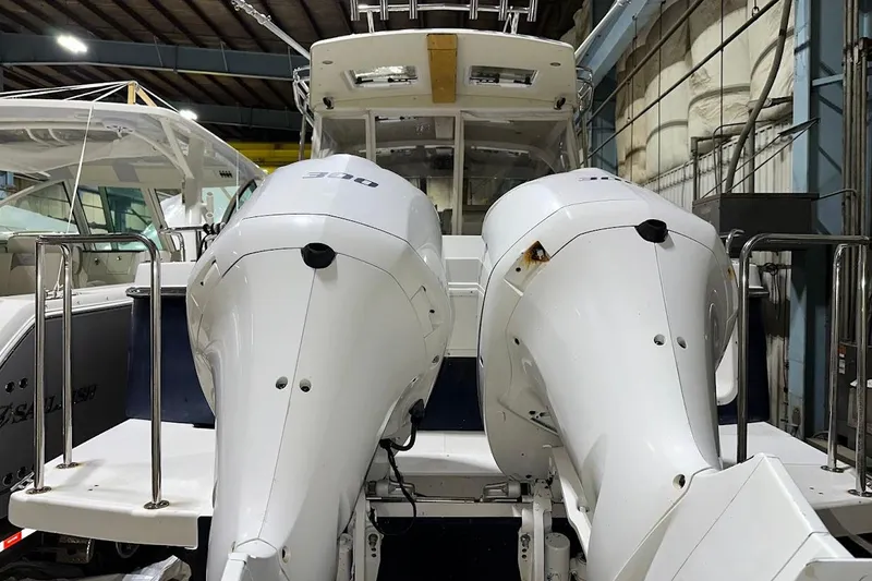 Slide: The Image of 2017 Cutwater C-302 Coupe with dual outboard engines in a storage facility. - 11