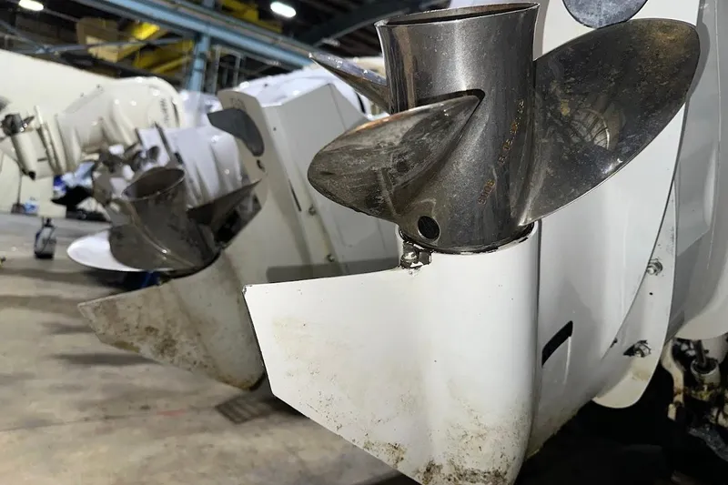 Slide: The Image of Close-up of 2017 Cutwater C-302 Coupe boat propellers in a workshop setting. - 12