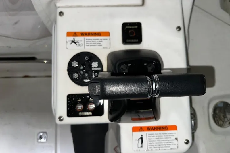Slide: The Image of 2017 Cutwater C-302 Coupe boat controls with Yamaha throttle and warning labels. - 18