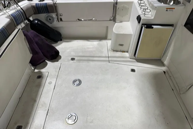 Slide: The Image of 2017 Cutwater C-302 Coupe boat interior with seating, storage, and sink area. - 19