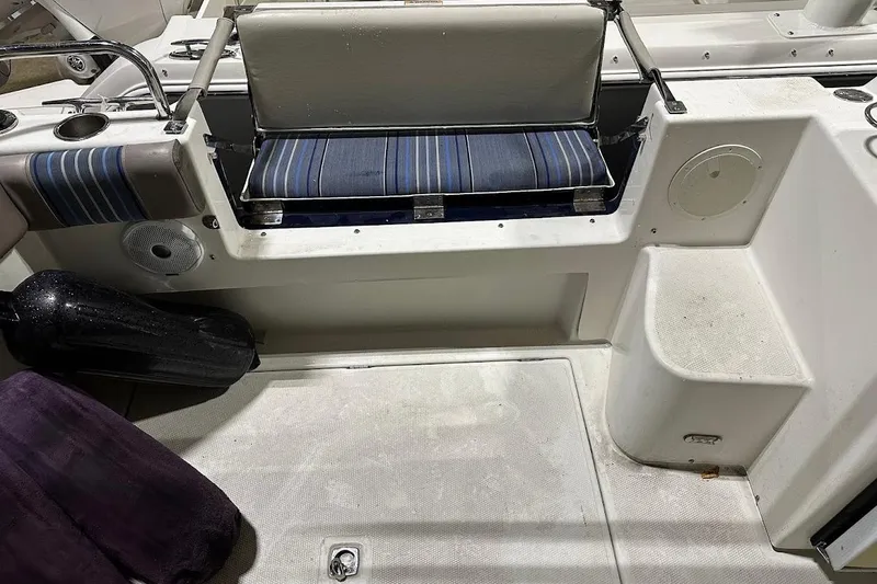 Slide: The Image of 2017 Cutwater C-302 Coupe interior with striped seating and marine accessories. - 21