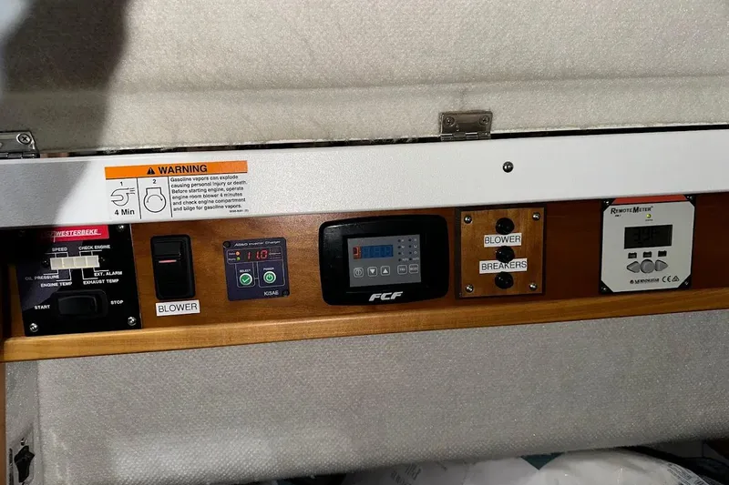 Slide: The Image of Control panel of a 2017 Cutwater C-302 Coupe boat with various switches and displays. - 24