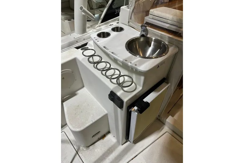 Slide: The Image of 2017 Cutwater C-302 Coupe boat interior with sink and cup holders. - 25