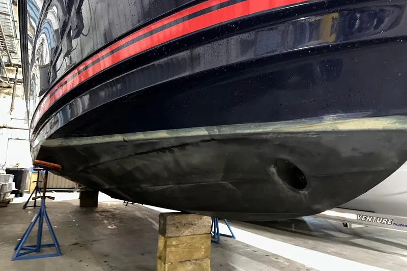 Slide: The Image of 2017 Cutwater C-302 Coupe boat hull in a maintenance facility. - 3