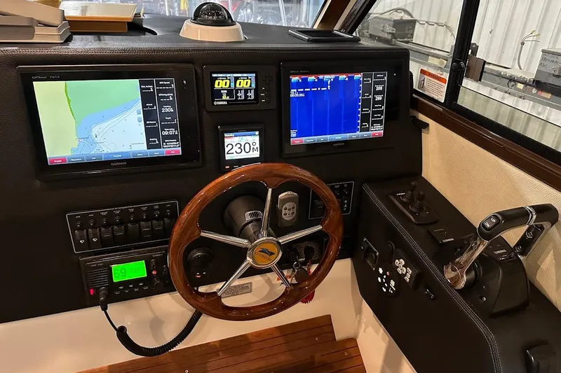 Slide: The Image of 2017 Cutwater C-302 Coupe helm with navigation screens and controls. - 37