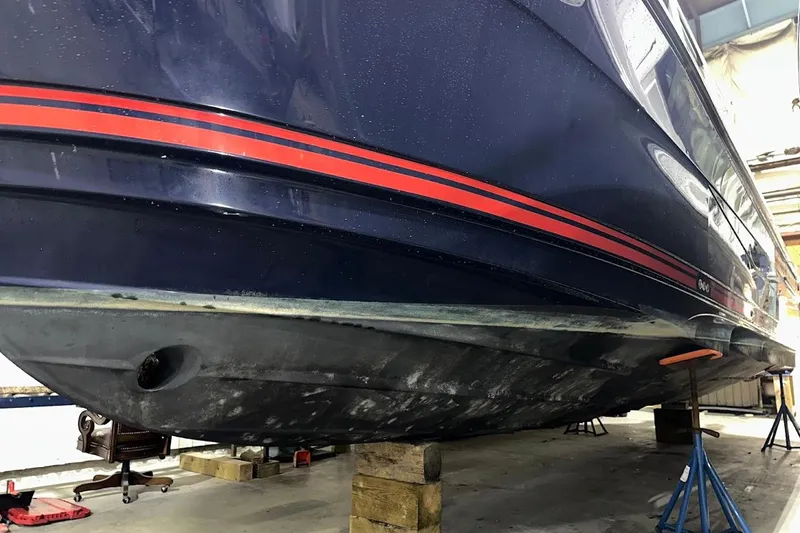 Slide: The Image of 2017 Cutwater C-302 Coupe boat on stands in a workshop. - 4