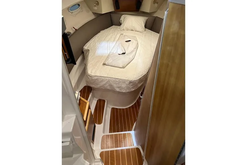 Slide: The Image of 2017 Cutwater C-302 Coupe cabin interior with cozy bed and wooden flooring. - 44