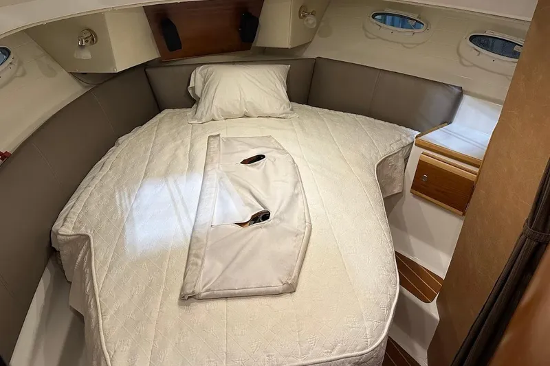 Slide: The Image of 2017 Cutwater C-302 Coupe cabin with cozy bed and porthole windows. - 45