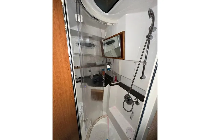 Slide: The Image of 2017 Cutwater C-302 Coupe bathroom with shower, mirror, and modern fixtures. - 49