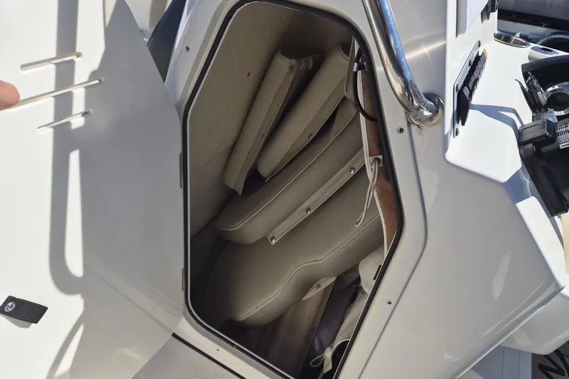 Slide: The Image of Storage compartment in 2022 Key West 203 FS boat with cushioned seats inside. - 14