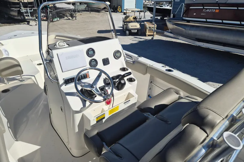Slide: The Image of 2022 Key West 203 FS boat interior with steering console and seating. - 8