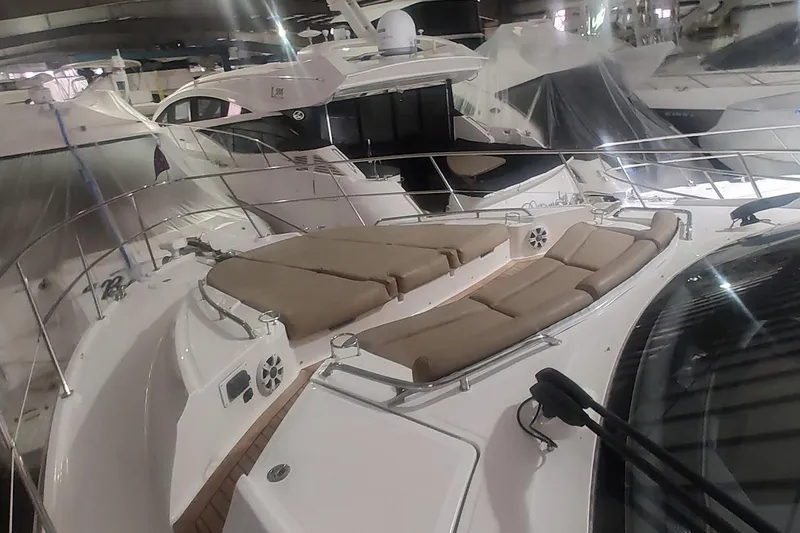 Slide: The Image of Luxurious 2016 Sea Ray L590 yacht interior with helm, seating, and elegant table setting. - 14