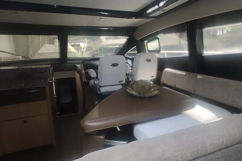 Slide: The Image of Luxurious 2016 Sea Ray L590 yacht bedroom with elegant decor and ambient lighting. - 22